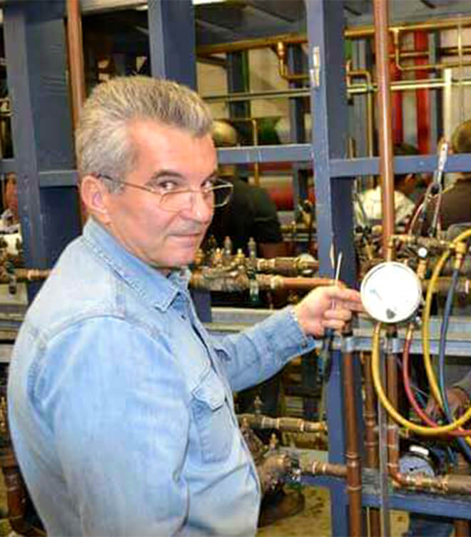 Dima - licensed master plumber working on a plumbing repair in a Toronto home